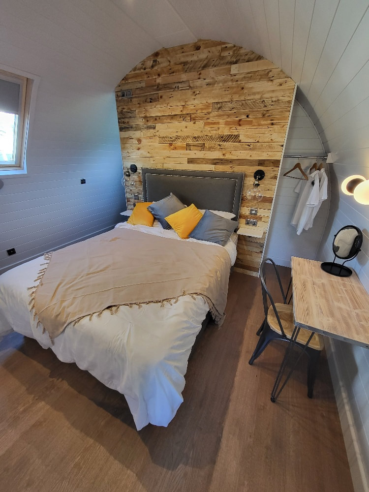1 or 2 bedroom glamping pod for sale with reclaimed timber wall.